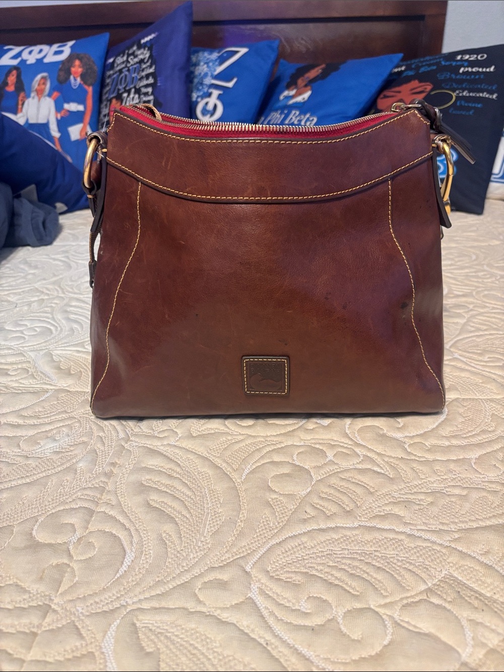 Dooney & Bourke Brown Leather Crossbody Hobo with Red Zip Accent